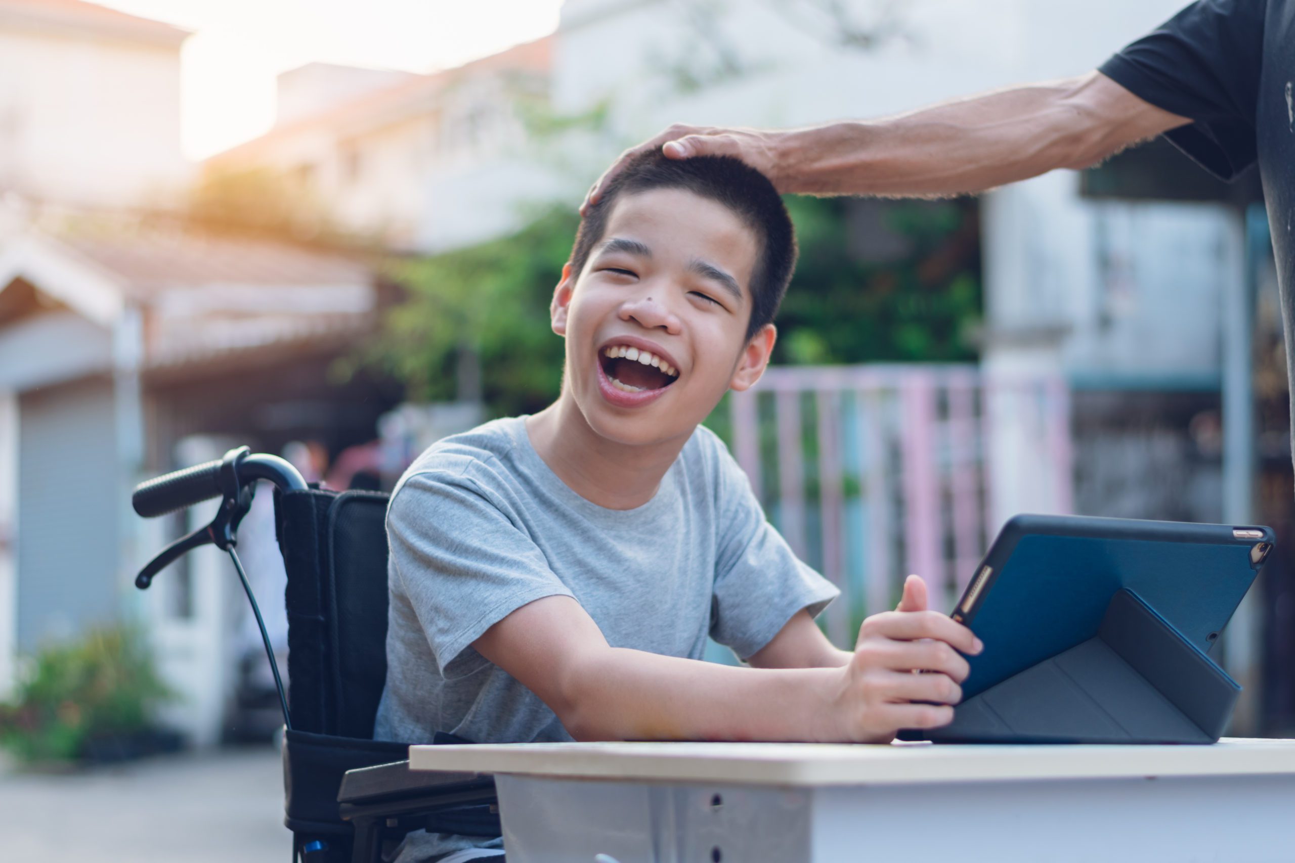 Disabled child on wheelchair happy time to use a tablet in the house, Study and Work at home for safety from covid 19, Life in the education age of special need kid, Happy disability boy concept.