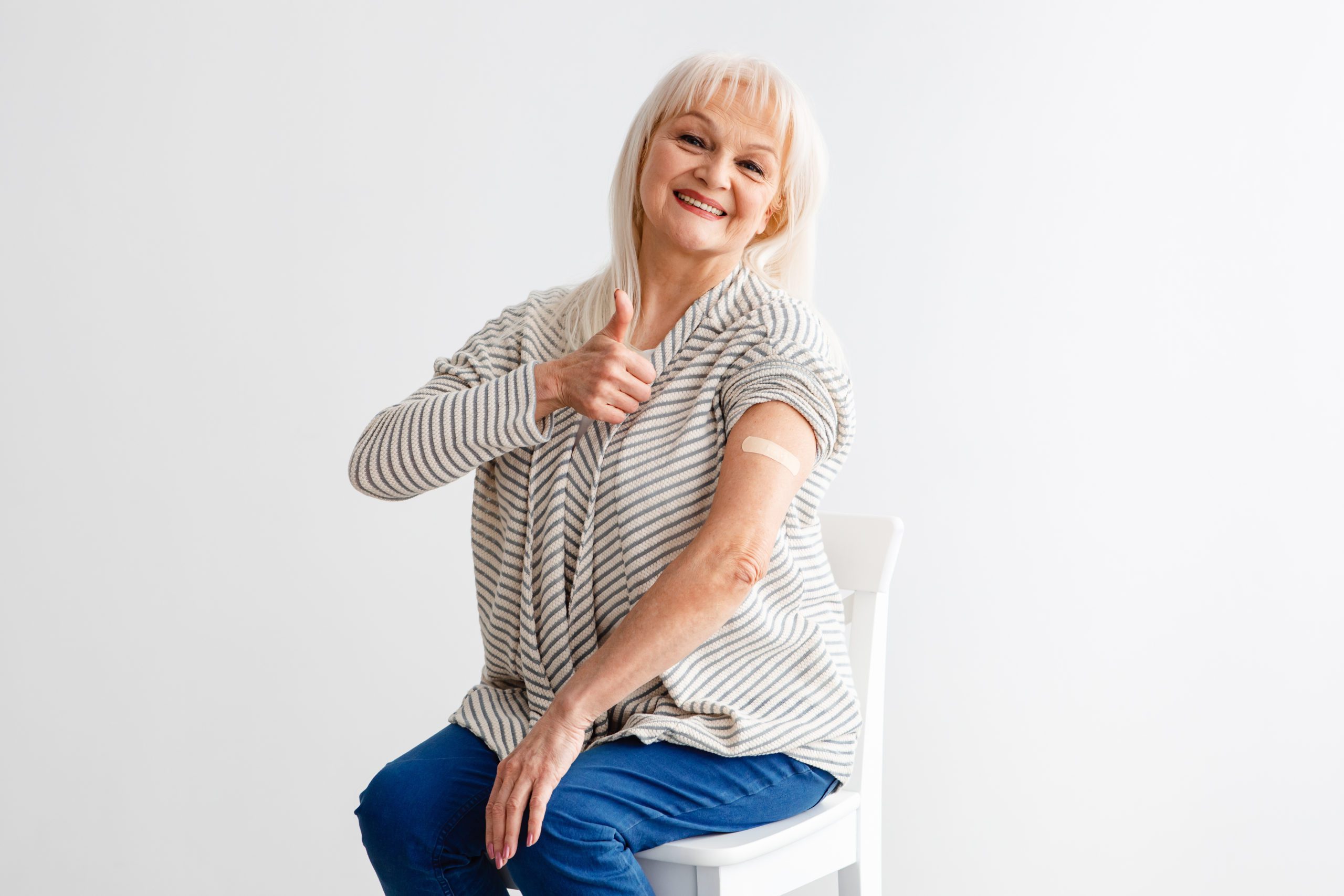 Happy Vaccinated Mature Lady Gesturing Thumbs-Up Over White Background