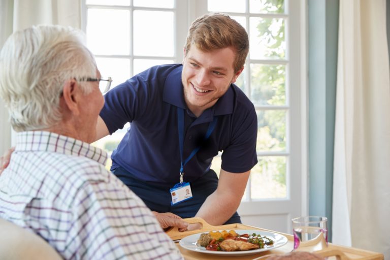 What is the role of a home care aide and how do they assist clients?